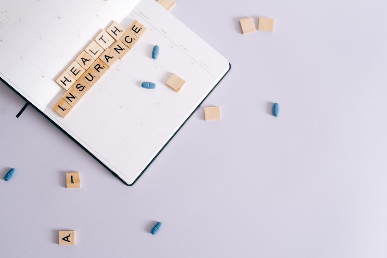 services-01 Flat lay of health insurance concept with planner and pills.